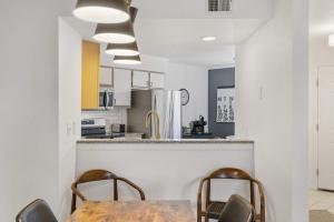 a kitchen with a wooden table and chairs at Ozark Retreat at the Pointe in Branson +22 photos