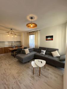 a living room with a couch and a table at Casa Del Mar in Shëngjin