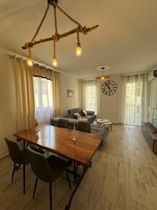 a living room with a table and a couch at Casa Del Mar in Shëngjin