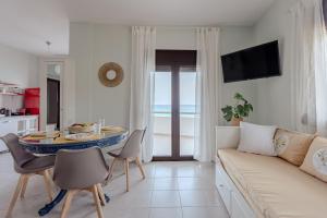 a living room with a couch and a table at Eclectic Vintage Apartment- Sea View Perfection, Hersonissos, Crete in Limín Khersonísou