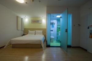 北京市にある7Days Inn Beijing Shangdiのベッドルーム1室(ベッド1台、ガラスドア付)