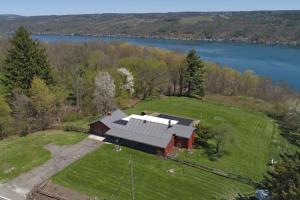 an aerial view of a barn on a field with a lake at Keuka Sunrise 