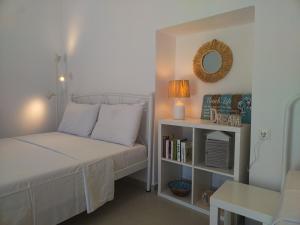 a small bedroom with a bed and a book shelf at Manos' Dream in Empourios