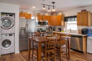 a kitchen with a table and chairs and a refrigerator at Blue Bungalow in Wayne