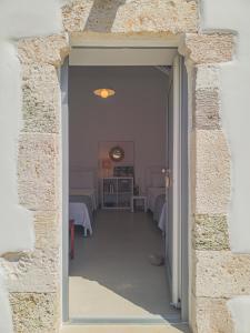 an open doorway to a room with beds at Manos' Dream in Empourios +30 photos