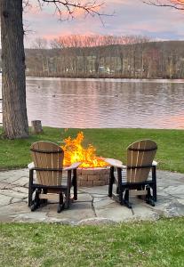 two chairs around a fire pit in a park at Lodge on Lamoka 