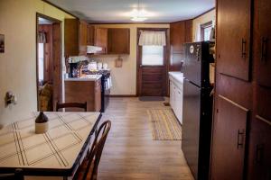 una piccola cucina con tavolo e frigorifero di Nannie Bell's Cottage a Dundee