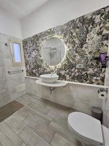 a bathroom with a sink and a mirror at Albatros B&B Porto Cesareo in Porto Cesareo +110 photos