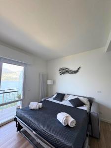 Katil atau katil-katil dalam bilik di MGH- Ora del Garda Lakeview Apartment