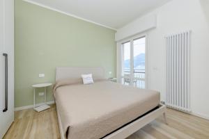 Postel nebo postele na pokoji v ubytování MGH- Peler del Garda Lakeview Apartment