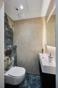 a bathroom with a toilet and a sink at Golden Hour Apartments- Loft H 418 in Świnoujście