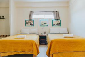 Ένα ή περισσότερα κρεβάτια σε δωμάτιο στο Casa Chetumal Hotel