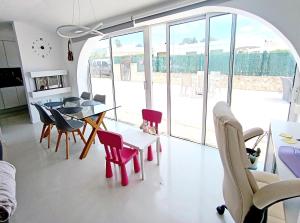 a living room with a table and chairs at CHALET CALAFAT in Calafat +22 photos
