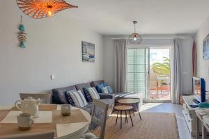 a living room with a couch and a table at El Veril del Duque Apartment in Adeje