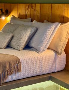 a bed with white pillows on top of it at Casa Cedro in Espera Feliz +57 photos