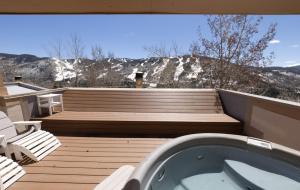 a deck with a jacuzzi tub sitting on a deck at Vail in Vail