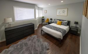 a bedroom with a bed and a dresser and a window at Vail in Vail