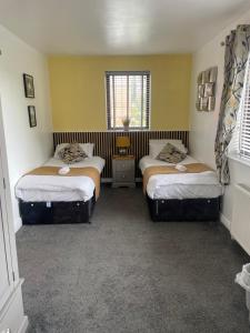 a room with two beds and a window at Camaraderie Guest House in York