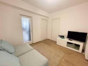 a living room with a couch and a flat screen tv at UNIKO Pineto in Pineto