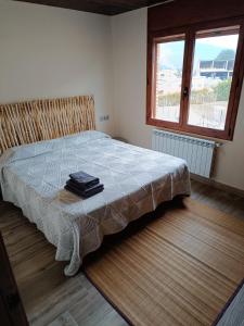 a bedroom with a bed with a blanket on it at El Castellot - Turisme rural in Cardona +13 photos