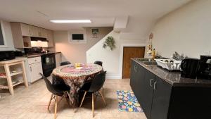 a kitchen with a table and chairs in a kitchen at Downtown-Jackson Park private Budget Friendly Room in Windsor