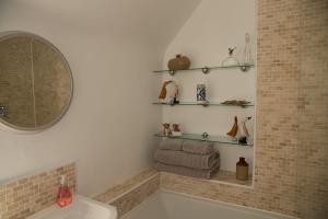 a bathroom with a sink and a mirror and towels at Snow Cottage, Old Aberdeen, 3 bedroom luxury in Aberdeen