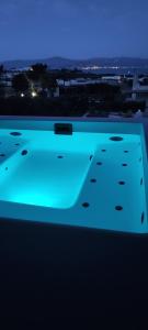 a view of a swimming pool at night at Island Magic - Seaview Villa with Jacuzzi Pool in Ambelas
