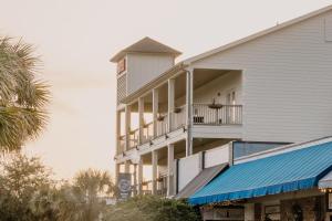 a white building with a clock tower on top of it at Hotel Whiskey in Pascagoula in Pascagoula