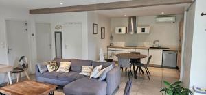 a living room with a couch and a kitchen at ANAHATA Appartement-Maison in Saint Paul de Vence