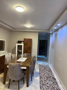 a dining room with a wooden table and chairs at الاغوار bb in Khirbat ash Shaykh Muḩammad +10 photos
