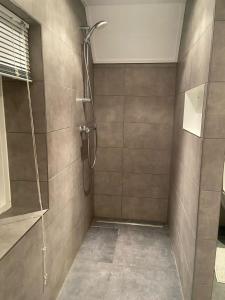 a bathroom with a shower with a glass door at Klassiek veluws huis onder de beuken in Barneveld +36 photos