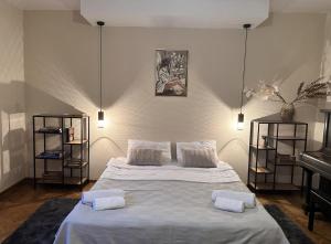 a bedroom with a large bed and a piano at Апартамент за гости НИКИА в центъра с изглед към Врачанския Балкан Nikia Cityscape & Mountain Escape in Vratsa