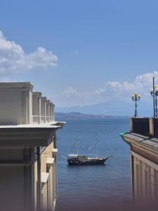 a boat in the water between two buildings at Izz Home in Naples