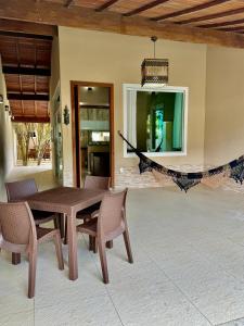 a wooden table and chairs on a patio at Casa lazer Atafona in São João da Barra