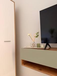 a flat screen tv sitting on top of a cabinet at Vila18 Vlore in Vlorë