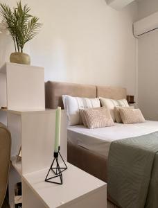a room with a bed and a candle on a table at Vila18 Vlore in Vlorë