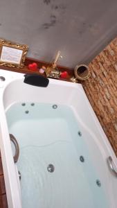 ピレノポリスにあるLOFT QUINTA DO ABADEのバスルーム(白いバスタブ、テーブル付)