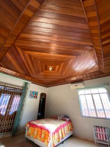a bedroom with a wooden ceiling and a bed at Casa Bio - Your place in COP 30 - Completa in Belém