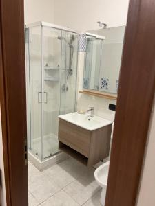 a bathroom with a shower and a sink and a toilet at Casa Minù in Latina