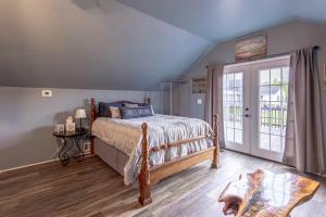 a bedroom with a bed and a sliding glass door at Over Garage Apartment Studio in Lincolnton