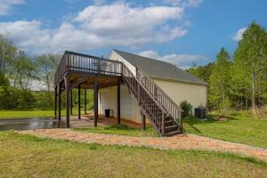 a house with a staircase in front of it at Over Garage Apartment Studio in Lincolnton