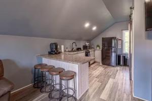 a kitchen with a counter and stools in a kitchen at Over Garage Apartment Studio in Lincolnton