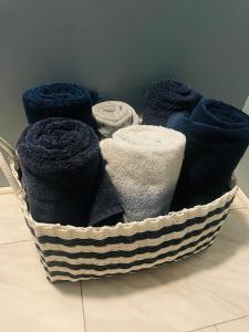 a basket filled with blue towels on the floor at Over Garage Apartment Studio in Lincolnton +22 photos