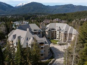 an aerial view of a resort with mountains at 1BR Condo with Ski Access Pool, Hot Tub, Gym & Sauna Free Bus in Whistler