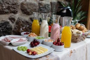 a table with a buffet of food and drinks at Bosco Hotel Boutique in Cusco