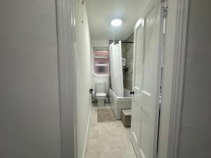 a small bathroom with a toilet and a window at Your Home in Southport! in Southport +21 photos