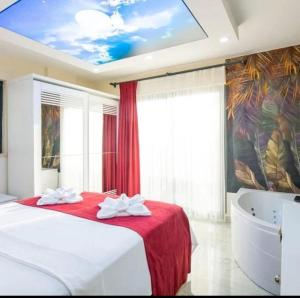 a bedroom with a large bed and a bath tub at VILLA KoSAR in Eskiömerler +28 photos