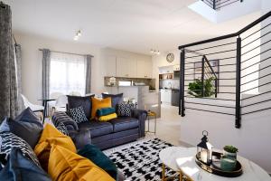 a living room with a couch and a kitchen at Craigavon Haven in Sandton