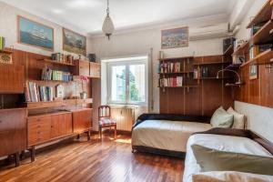 een slaapkamer met een bed, een bureau en boekenplanken bij Anna luxury apartment Salario Parioli Rome in Rome