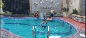 a group of people in a swimming pool at Hotel Oasis in Riberalta